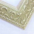 A large, reverse curve profile frame with an intricate leaf design bordered by a geometric outer edge and beaded inner lip. A White matte base with patina for added depth on the topmost points of the design. Strong, solid wood construction.
3.25 " witdth: ideal for large and oversize (extra large) images.